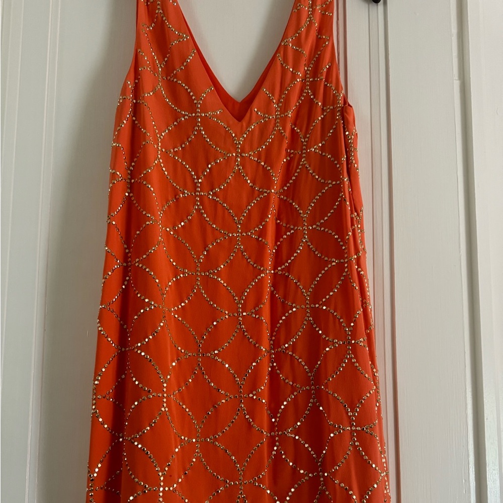 Trina Turk sleeveless dress. Deep V neck, orange color with gold embellishment